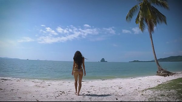 Micro bikini tease by sexy teen who walks on a beach